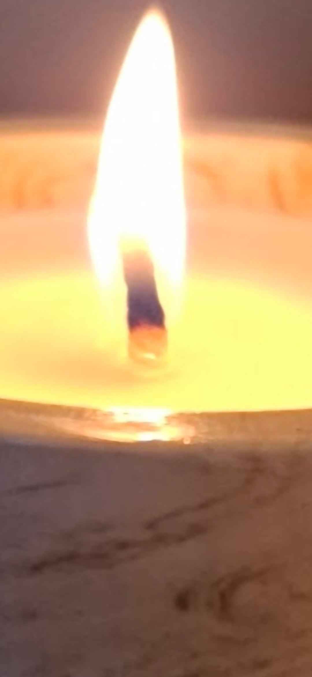 Úr flickering candle flame with close up image.